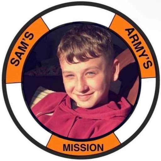 Sam Haycock, smiling, shown within the Sam's Army life-ring badge
