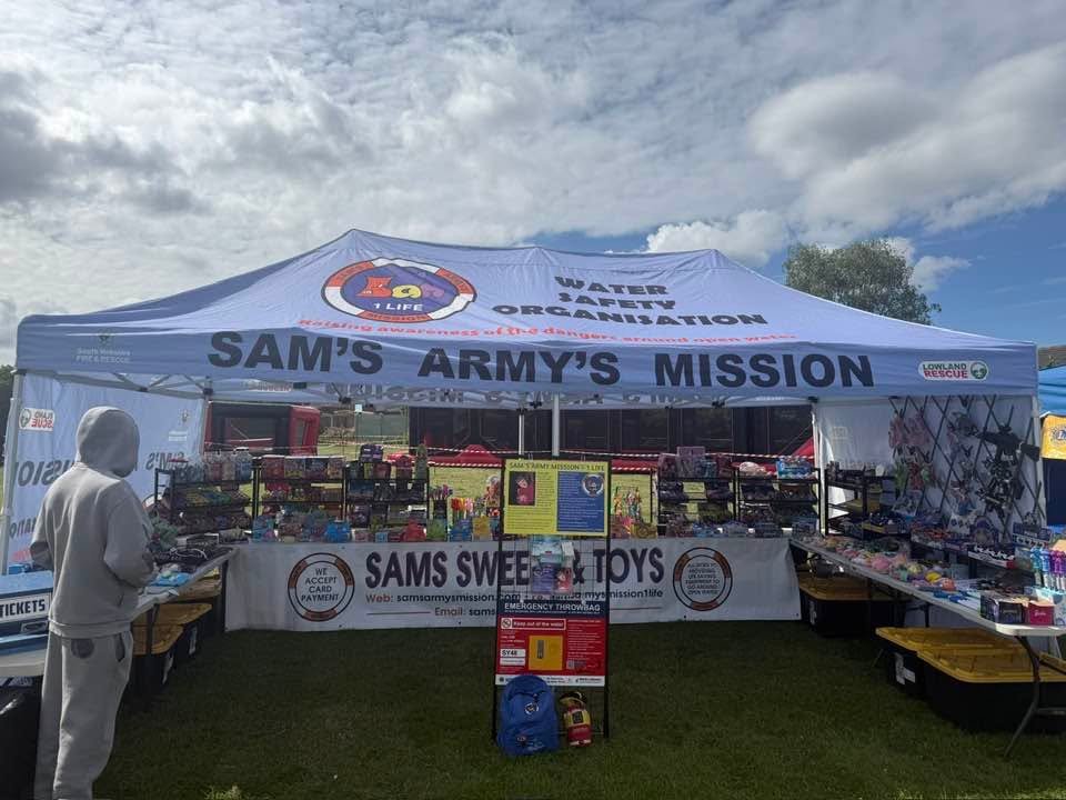 A large Sam's Army's Mission gazebo stocked with sweets, toys and water-safety information.